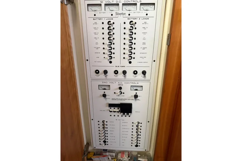 Slide: The Image of Control panel of a 1997 Silverton 442 Cockpit Motor Yacht, featuring electrical switches and gauges. - 18