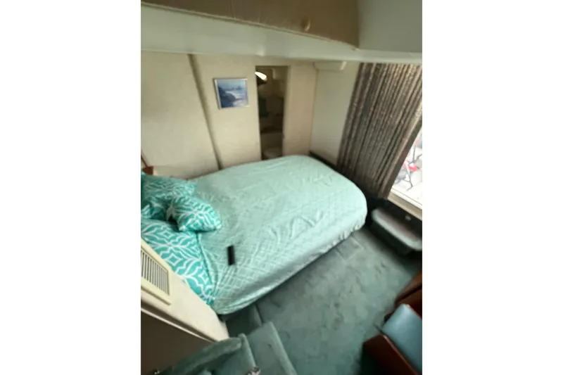 Slide: The Image of Interior cabin of 1997 Silverton 442 Cockpit Motor Yacht with bed and window view. - 19