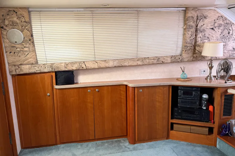 Slide: The Image of Interior of 1997 Silverton 442 Cockpit Motor Yacht with wooden cabinets and blinds. - 25