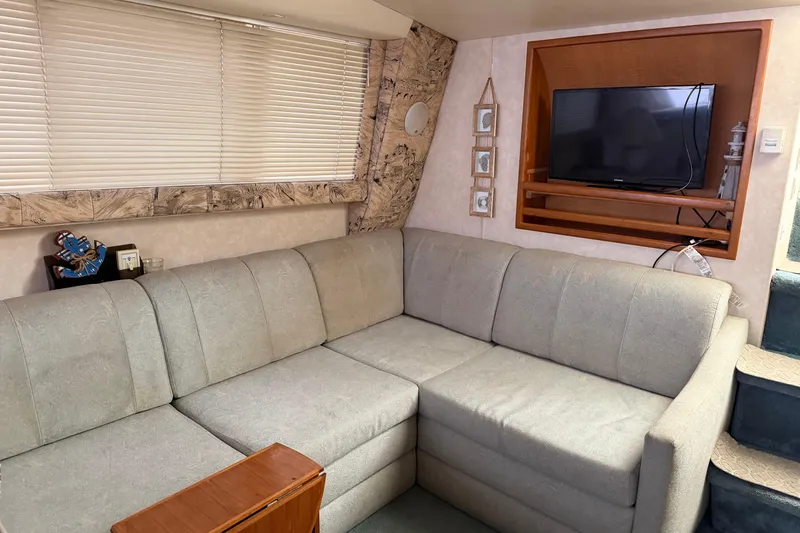 Slide: The Image of Interior of 1997 Silverton 442 Cockpit Motor Yacht with cozy seating and TV. - 27