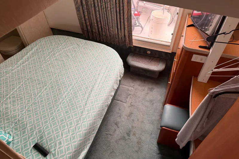 Slide: The Image of Interior cabin of 1997 Silverton 442 Cockpit Motor Yacht with bed and window view. - 28