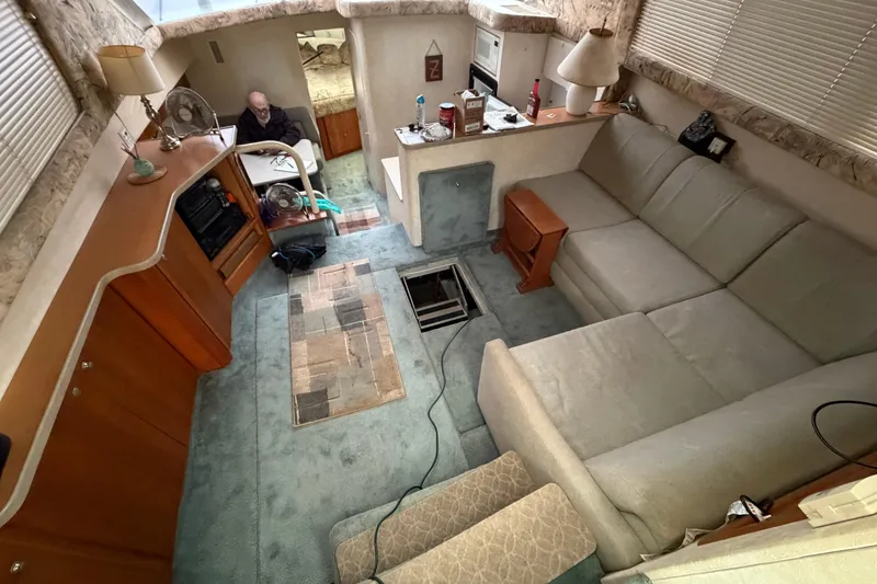 Slide: The Image of Interior of a 1997 Silverton 442 Cockpit Motor Yacht with cozy seating and kitchenette. - 29