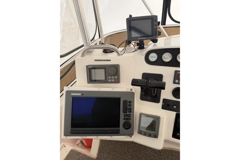 Slide: The Image of 1997 Silverton 442 Cockpit Motor Yacht helm with navigation equipment and controls. - 3
