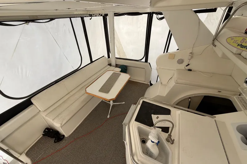 Slide: The Image of 1997 Silverton 442 Cockpit Motor Yacht interior with seating and table. - 30