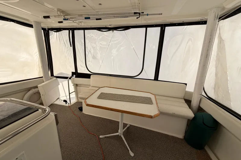 Slide: The Image of Interior of 1997 Silverton 442 Cockpit Motor Yacht with seating and table. - 32