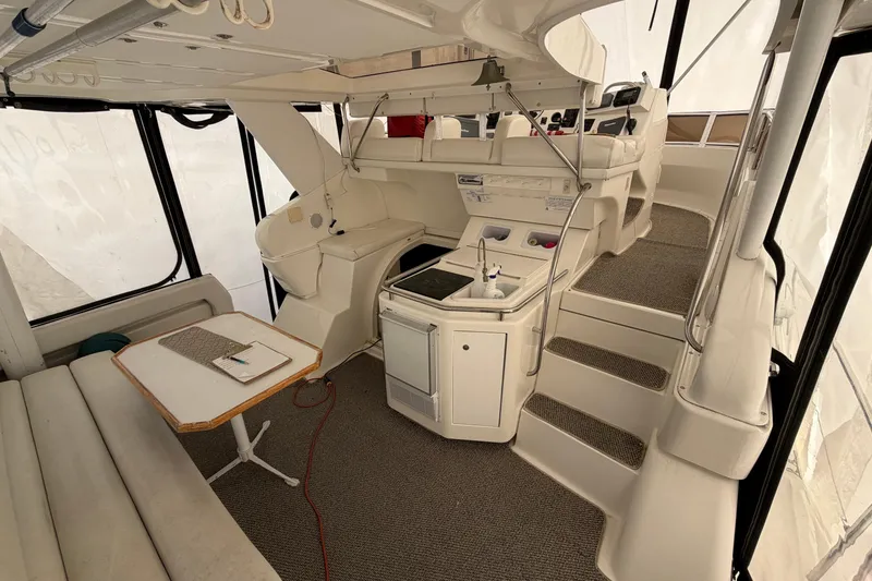 Slide: The Image of Interior of a 1997 Silverton 442 Cockpit Motor Yacht with seating and kitchenette. - 33