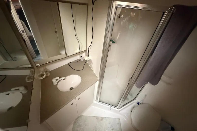 Slide: The Image of Bathroom interior of 1997 Silverton 442 Cockpit Motor Yacht with shower and sink. - 35