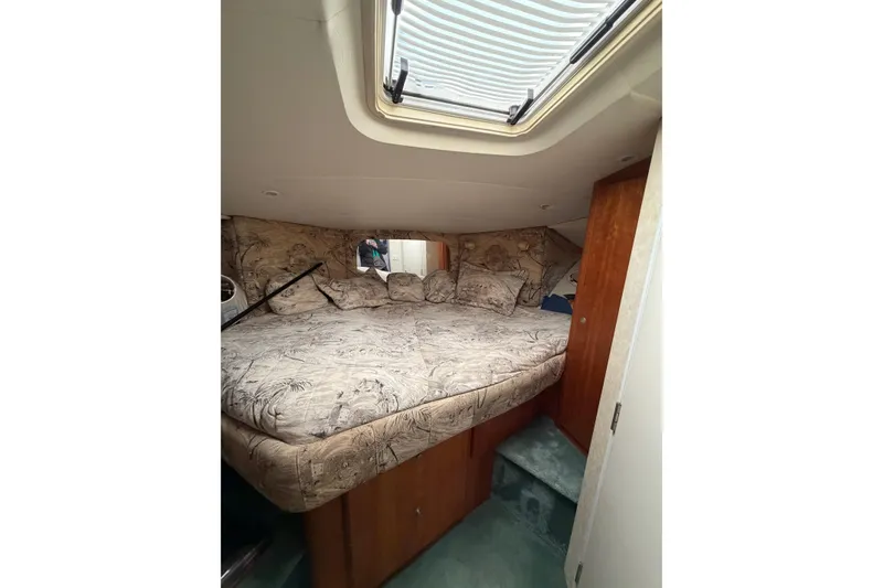 Slide: The Image of Interior cabin of 1997 Silverton 442 Cockpit Motor Yacht with cozy bed and skylight. - 36