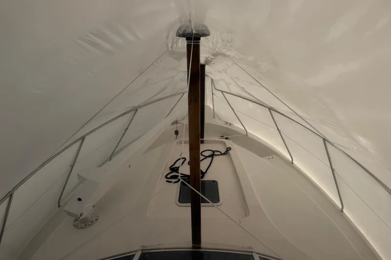 Slide: The Image of 1997 Silverton 442 Cockpit Motor Yacht under protective cover, showcasing deck and railings. - 37