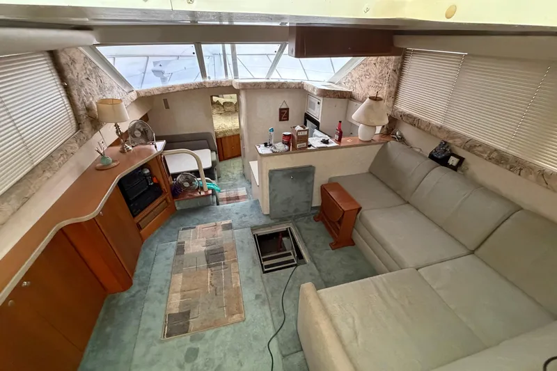 Slide: The Image of Interior of a 1997 Silverton 442 Cockpit Motor Yacht with cozy seating and decor. - 39