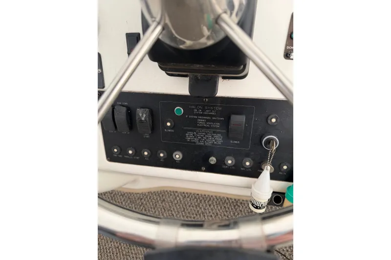 Slide: The Image of Control panel of a 1997 Silverton 442 Cockpit Motor Yacht with steering wheel. - 5