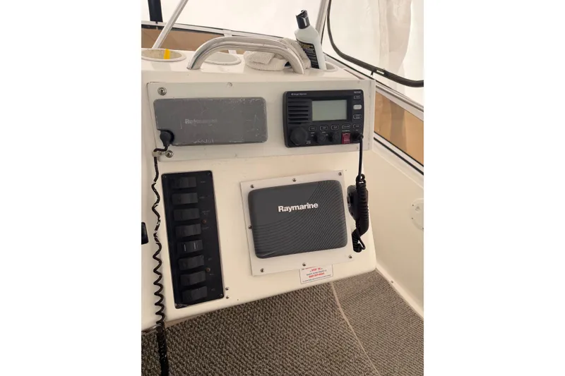 Slide: The Image of Control panel of a 1997 Silverton 442 Cockpit Motor Yacht with Raymarine equipment. - 6