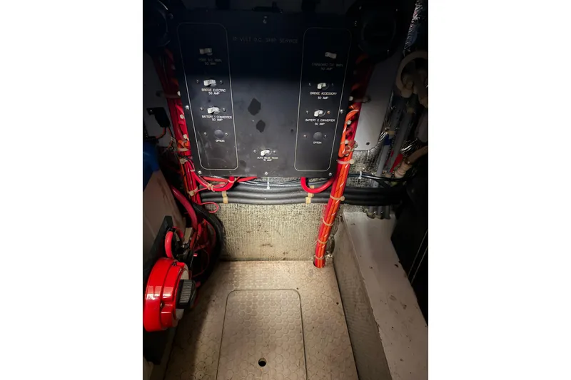 Slide: The Image of Engine room of a 1997 Silverton 442 Cockpit Motor Yacht, featuring electrical panels and wiring. - 8