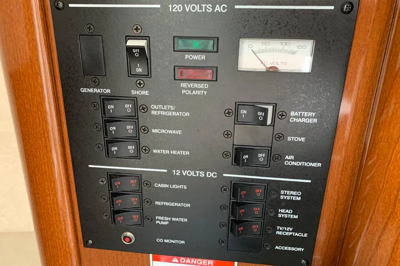 Slide: The Image of Electrical control panel on a 2011 Sea Ray 240 Sundancer boat. - 21