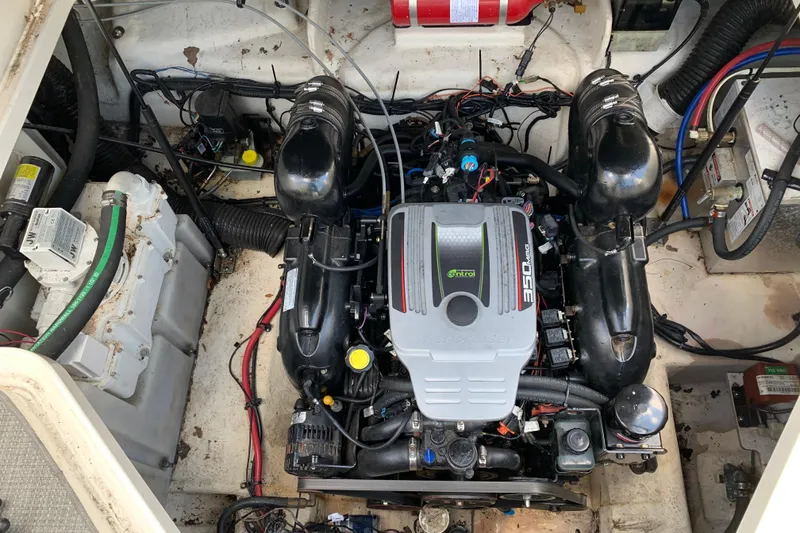 Slide: The Image of Engine compartment of a 2011 Sea Ray 240 Sundancer boat, featuring a MerCruiser 350 MAG engine. - 24