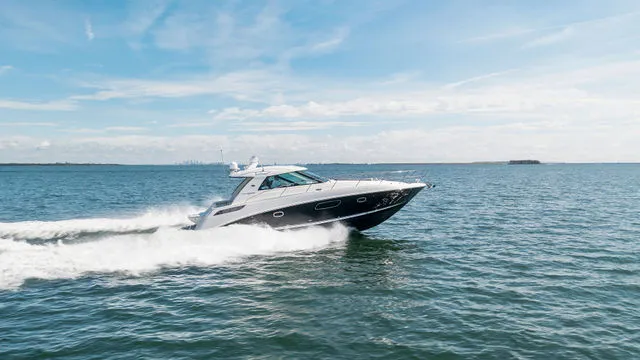 Slide: The Image of 2011 Sea Ray 240 Sundancer helm with Garmin GPS and wood-accented steering wheel. - 9