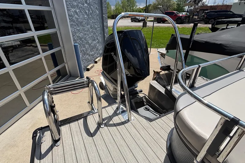 Slide: The Image of 2023 Princecraft Quorum 25 RL pontoon boat with outboard motor and ladder. - 14