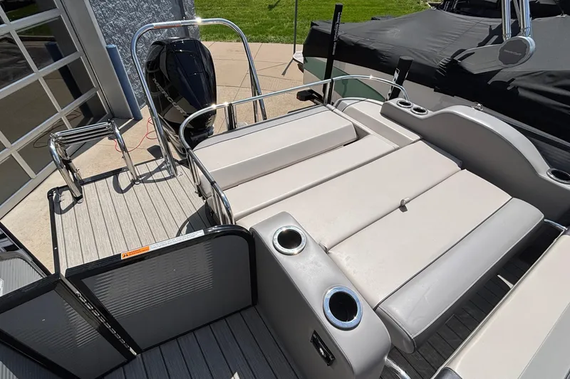Slide: The Image of 2023 Princecraft Quorum 25 RL pontoon boat with spacious seating and modern design. - 16