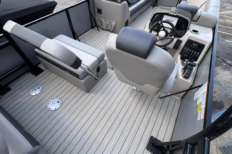 Slide: The Image of 2023 Princecraft Quorum 25 RL boat interior with steering console and seating. - 20