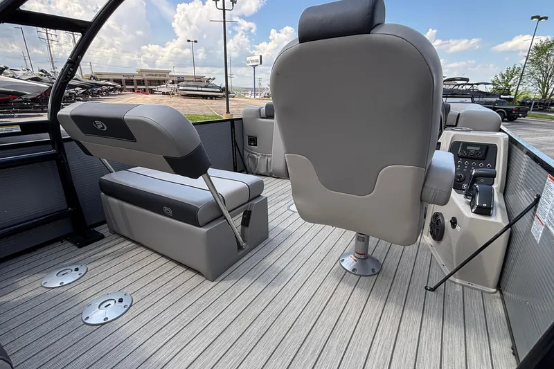 Slide: The Image of 2023 Princecraft Quorum 25 RL boat interior with gray seating and control panel. - 21