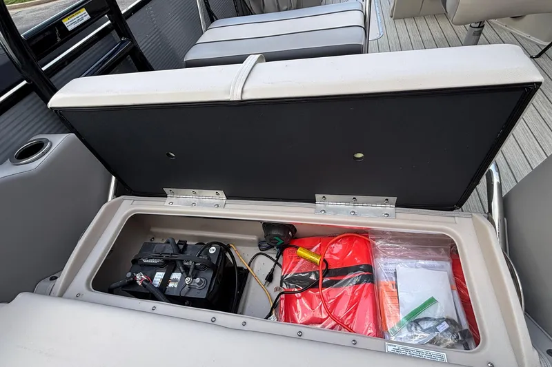 Slide: The Image of Storage compartment of 2023 Princecraft Quorum 25 RL with battery and safety equipment. - 27