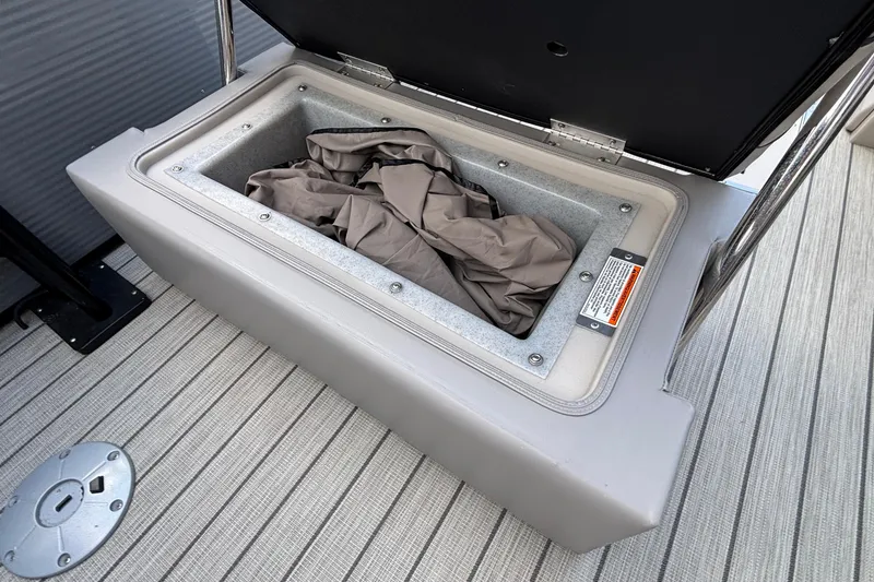 Slide: The Image of Open storage compartment on 2023 Princecraft Quorum 25 RL boat deck. - 28