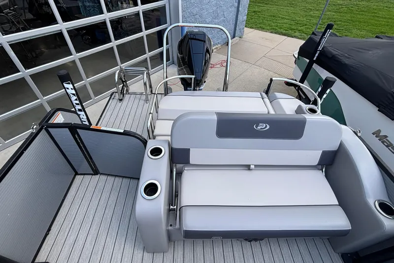 Slide: The Image of 2023 Princecraft Quorum 25 RL pontoon boat with seating and cup holders. - 29