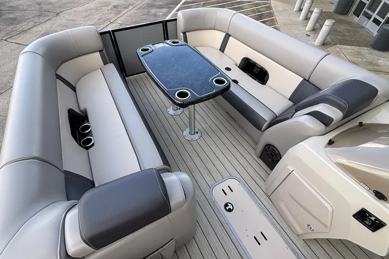 Slide: The Image of 2023 Princecraft Quorum 25 RL boat interior with plush seating and sleek table design. - 31