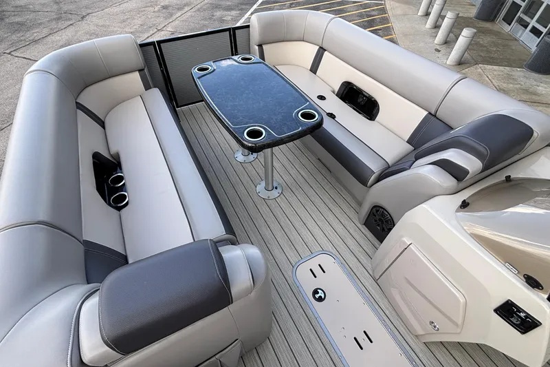 Slide: The Image of 2023 Princecraft Quorum 25 RL boat interior with plush seating and central table. - 32