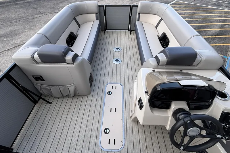 Slide: The Image of 2023 Princecraft Quorum 25 RL pontoon boat interior with plush seating and modern helm. - 33