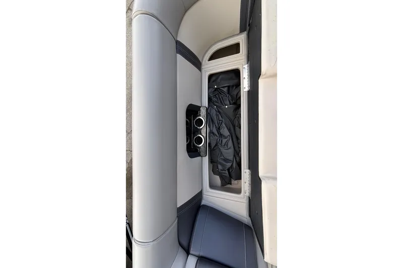Slide: The Image of 2023 Princecraft Quorum 25 RL boat interior storage compartment with cup holders. - 36