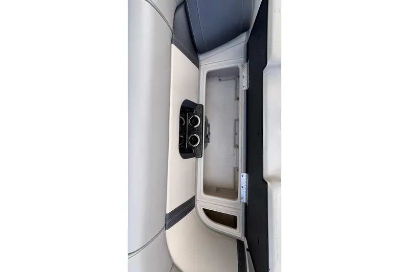 Slide: The Image of 2023 Princecraft Quorum 25 RL boat interior storage compartment with cup holders. - 37