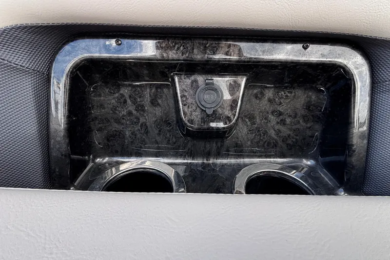 Slide: The Image of 2023 Princecraft Quorum 25 RL boat console with USB port and cup holders. - 38