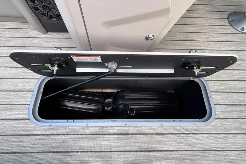 Slide: The Image of Open storage compartment on 2023 Princecraft Quorum 25 RL boat, revealing interior space. - 41