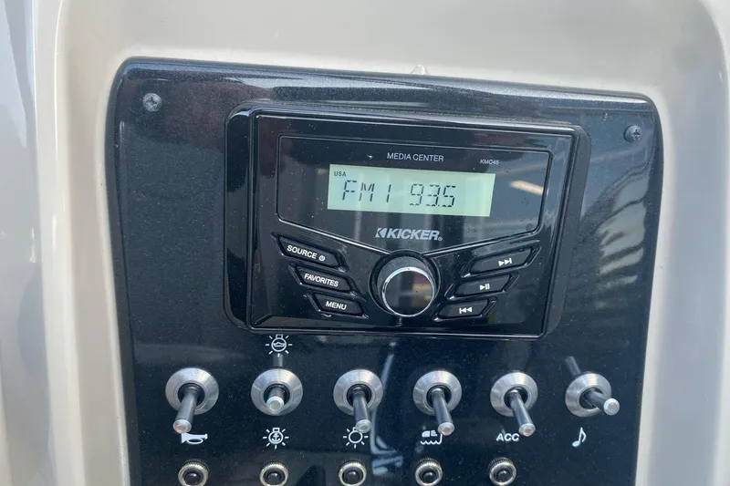 Slide: The Image of 2023 Princecraft Quorum 25 RL media center with Kicker radio tuned to FM 93.6. - 47