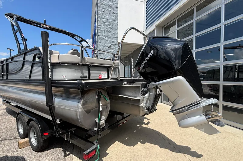 Slide: The Image of 2023 Princecraft Quorum 25 RL pontoon boat with Mercury outboard motor on trailer. - 5