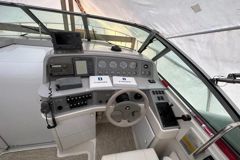 Slide: The Image of Cockpit of a 1997 Formula 34 Performance Cruiser with navigation instruments and steering wheel. - 10