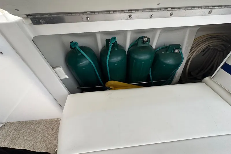 Slide: The Image of Storage compartment with green fenders on a 1997 Formula 34 Performance Cruiser boat. - 12