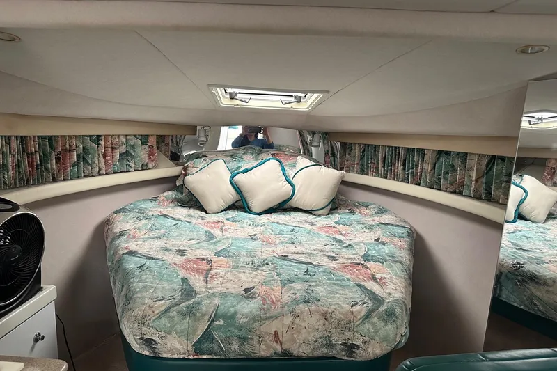 Slide: The Image of 1997 Formula 34 Performance Cruiser cabin with patterned bedding and pillows. - 17