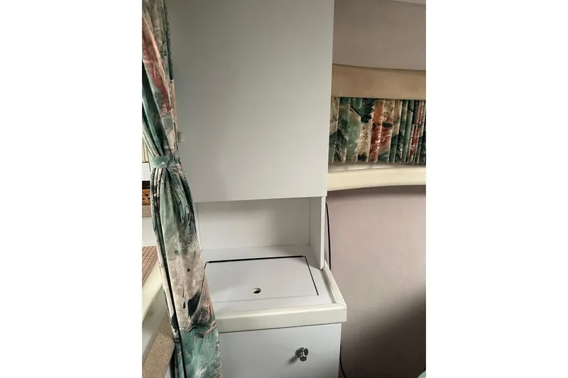 Slide: The Image of Interior of 1997 Formula 34 Performance Cruiser with storage cabinet and patterned curtains. - 18