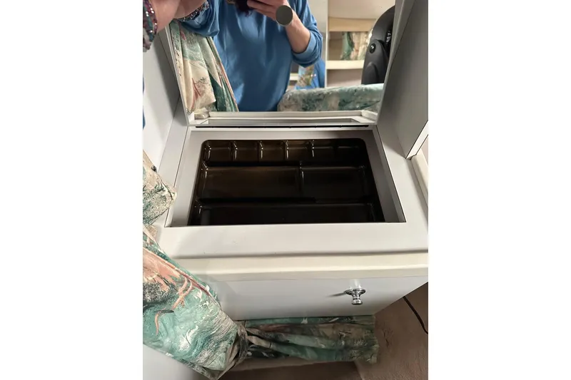 Slide: The Image of 1997 Formula 34 Performance Cruiser interior with storage compartment and floral curtains. - 19