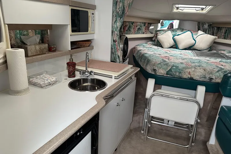 Slide: The Image of 1997 Formula 34 Performance Cruiser interior with kitchenette and cozy sleeping area. - 25