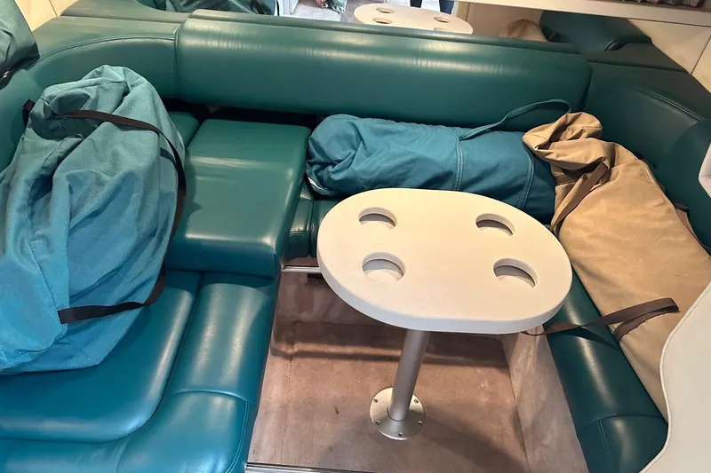 Slide: The Image of 1997 Formula 34 Performance Cruiser interior with teal seating and a small table. - 28