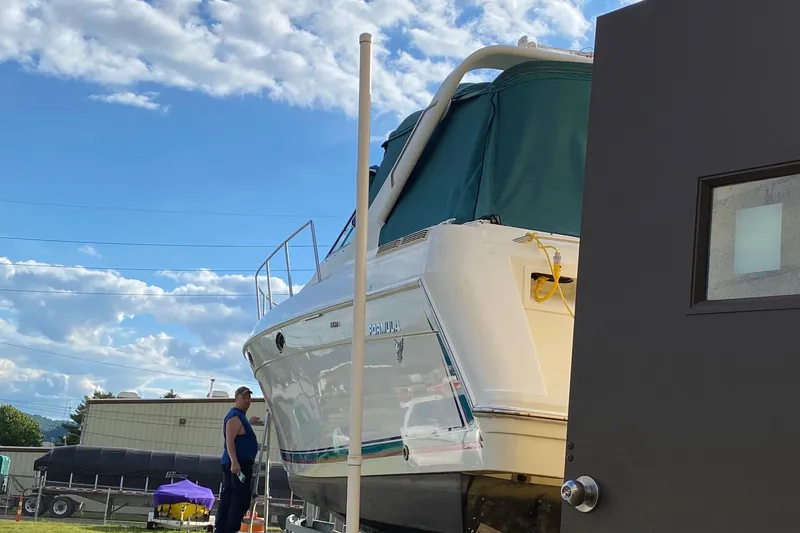 Slide: The Image of 1997 Formula 34 Performance Cruiser docked outdoors under a blue sky. - 4