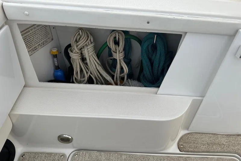Slide: The Image of Storage compartment on a 1997 Formula 34 Performance Cruiser with ropes and cleaning supplies. - 7