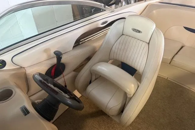 Slide: The Image of Interior of 2002 Chaparral 216 SSi boat with beige seating and steering wheel. - 12