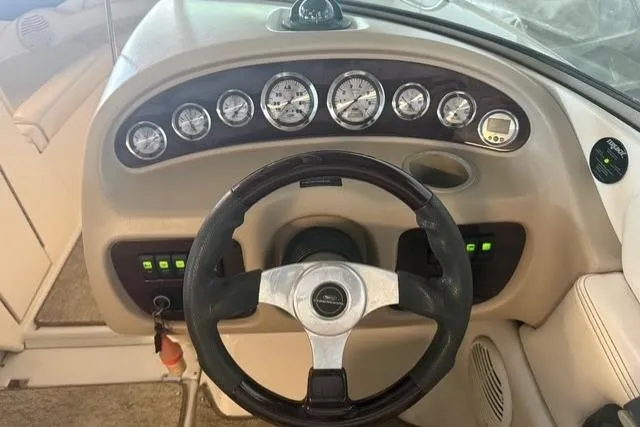 Slide: The Image of 2002 Chaparral 216 SSi boat dashboard with steering wheel and instrument gauges. - 13