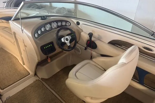 Slide: The Image of Interior view of a 2002 Chaparral 216 SSi boat, featuring a sleek dashboard and steering wheel. - 15