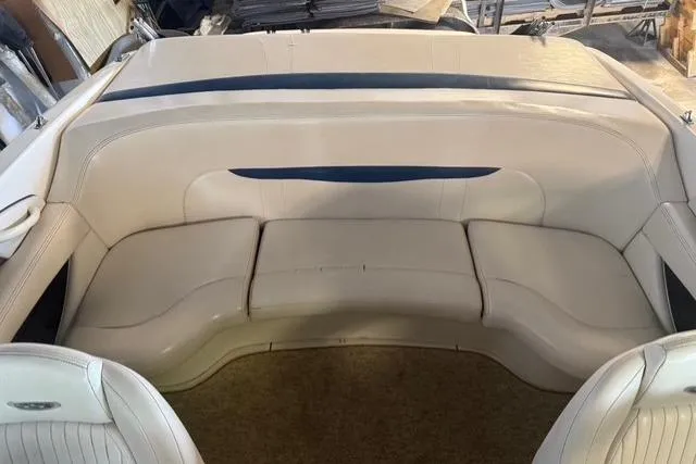 Slide: The Image of Interior seating of a 2002 Chaparral 216 SSi boat, featuring cream upholstery. - 16