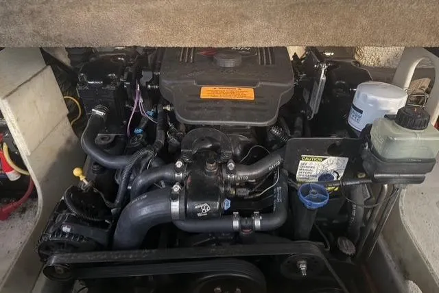 Slide: The Image of Engine compartment of a 2002 Chaparral 216 SSi boat, showcasing mechanical components. - 18